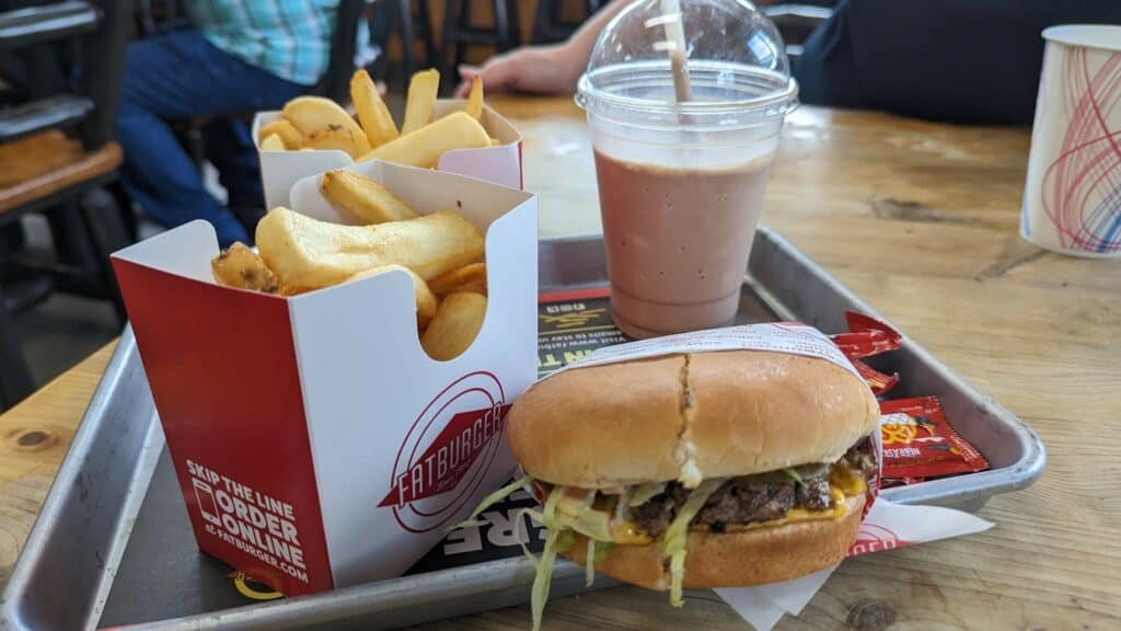 photo of a thousand island burger, fries, and chocolate shake at a fatburger restaurant